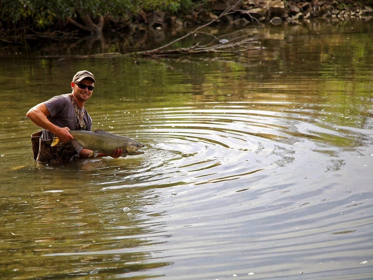 A fishing net laid out with tackle on the bank